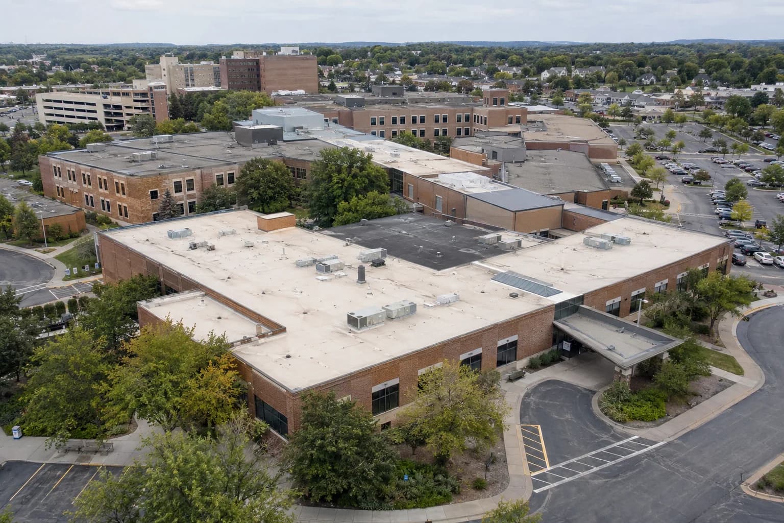 Aerial view of an office campus with roofs of different ages and materials