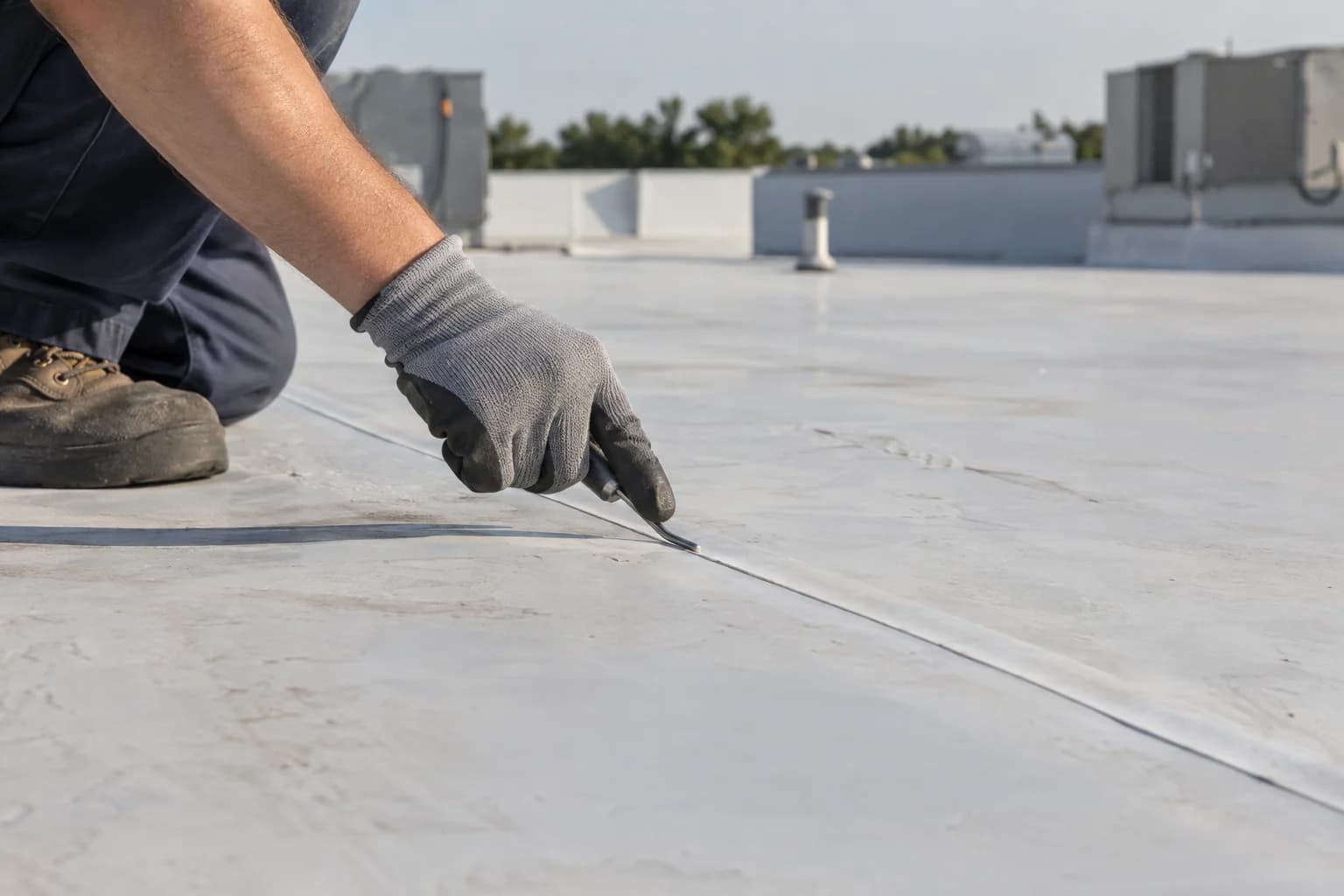 An inspector checking a completed membrane weld with a seam probe
